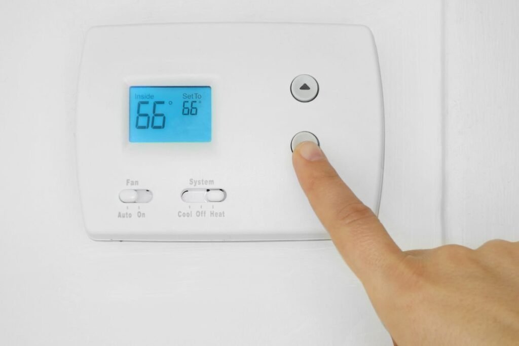 A person checking why the thermostat goes above set temp.