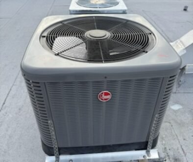 HVAC replacement heat pump installed on a roof, with a visible fan, used to air-condition the building