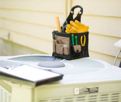 2-ton AC unit with tools and clipboard, representing professional installation and maintenance for energy-efficient home cooling.