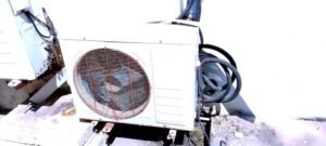 Two air conditioning units on a metal cage, accompanied by the noise of running compressors.
