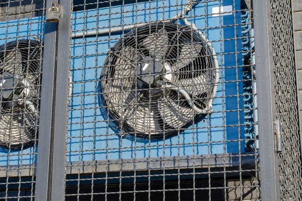 Two air conditioners mounted on a metal cage, with the sound of AC compressors humming in the background.