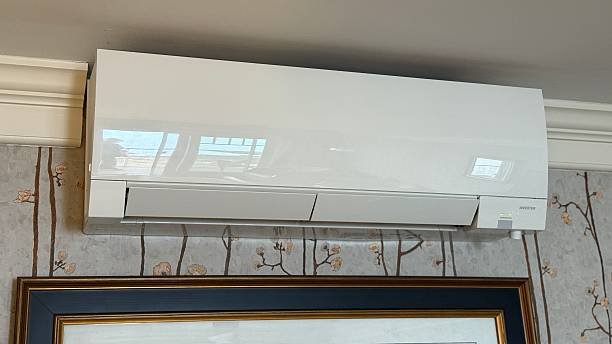 A white ductless mini split air conditioner mounted on the wall, providing efficient cooling for the room.