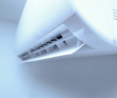 Wall AC unit in a bright white room, enhanced by a soft blue glow.