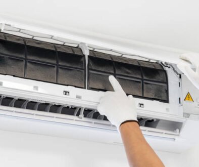 A technician repairs an air conditioner that is not turning on, carefully examining the unit with tools in hand — a common AC not turning on service scenario.