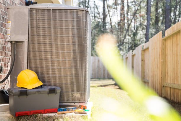 How Can HVAC Service Improve Efficiency and Reduce Bills? 2 HVAC unit with a hard hat and toolbox, symbolizing professional HVAC service and maintenance readiness.