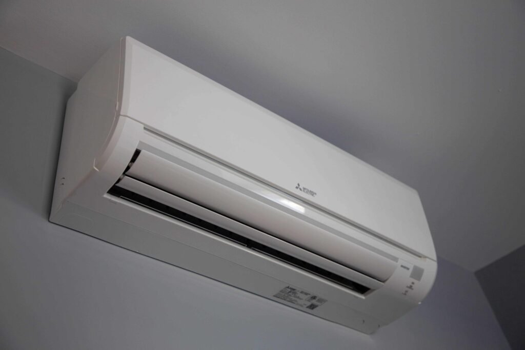 A white ductless air conditioner mounted on a wall, showcasing a clean and modern installation.