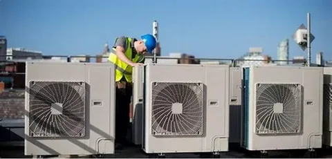 licensed HVAC professionals repairing air conditioning system in residential home